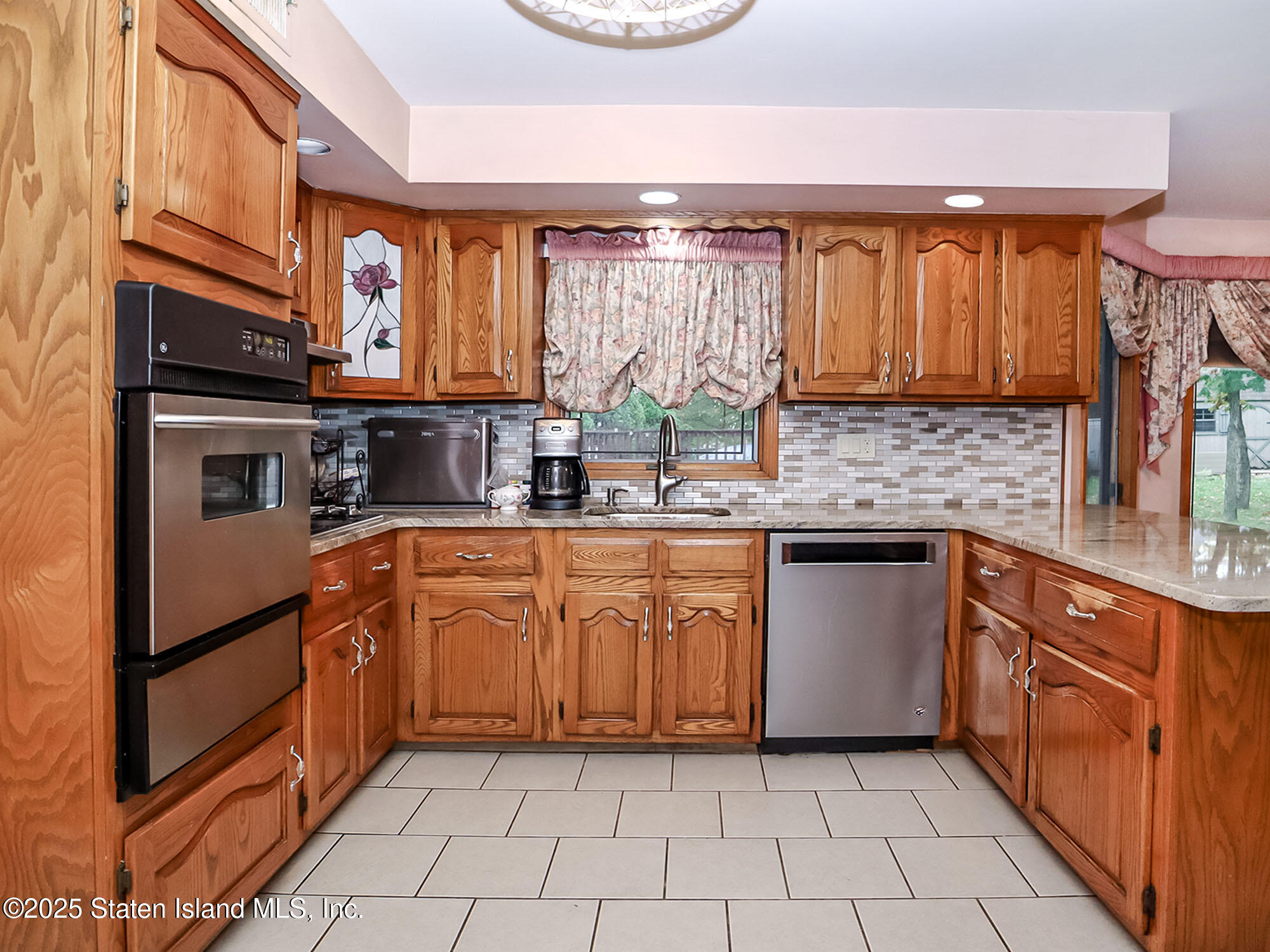 282 Boscombe Avenue Staten Island, NY 10309 - Photo 9 of 34 a kitchen with stainless steel appliances granite countertop a sink stove and cabinets