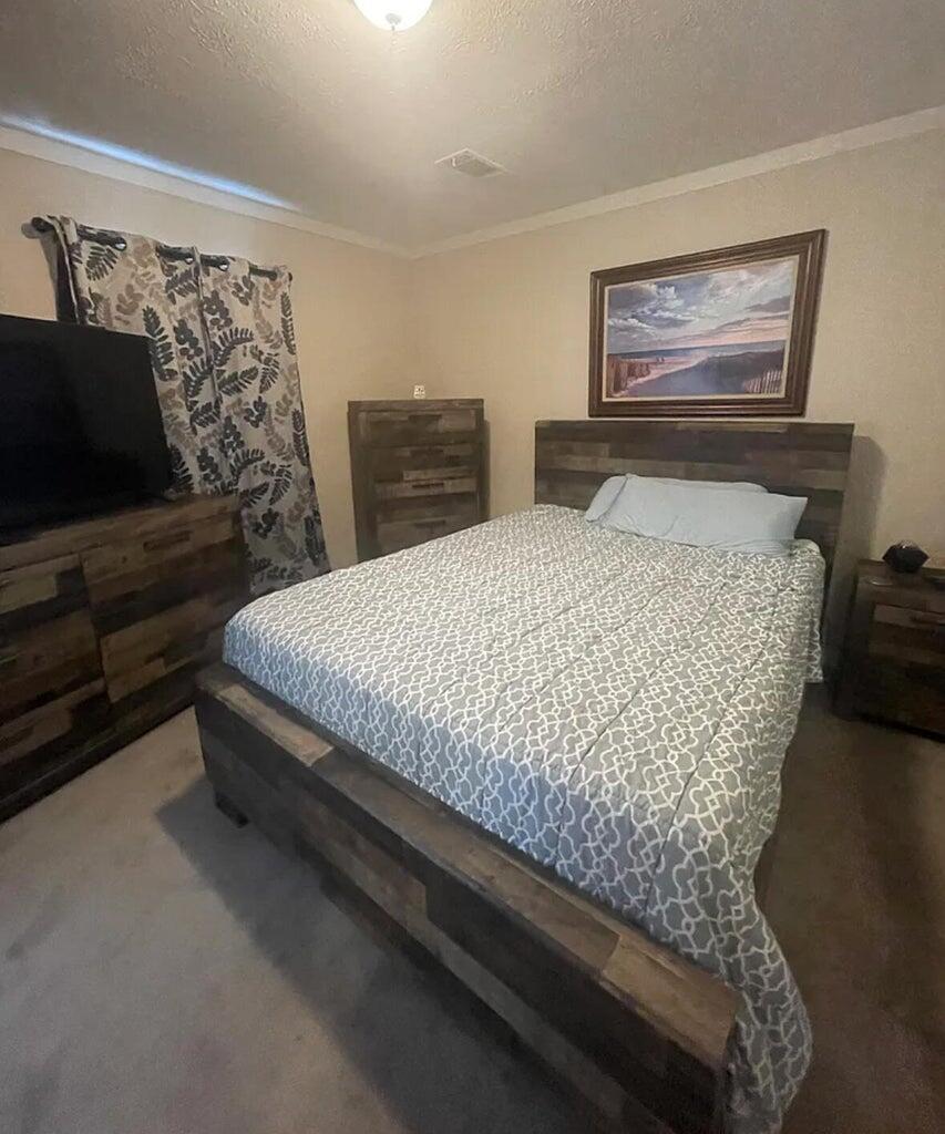 356 Mockingbird Avenue Fort Pierce, FL 34982 - Photo 4 of 12 a bedroom with a bed and dresser