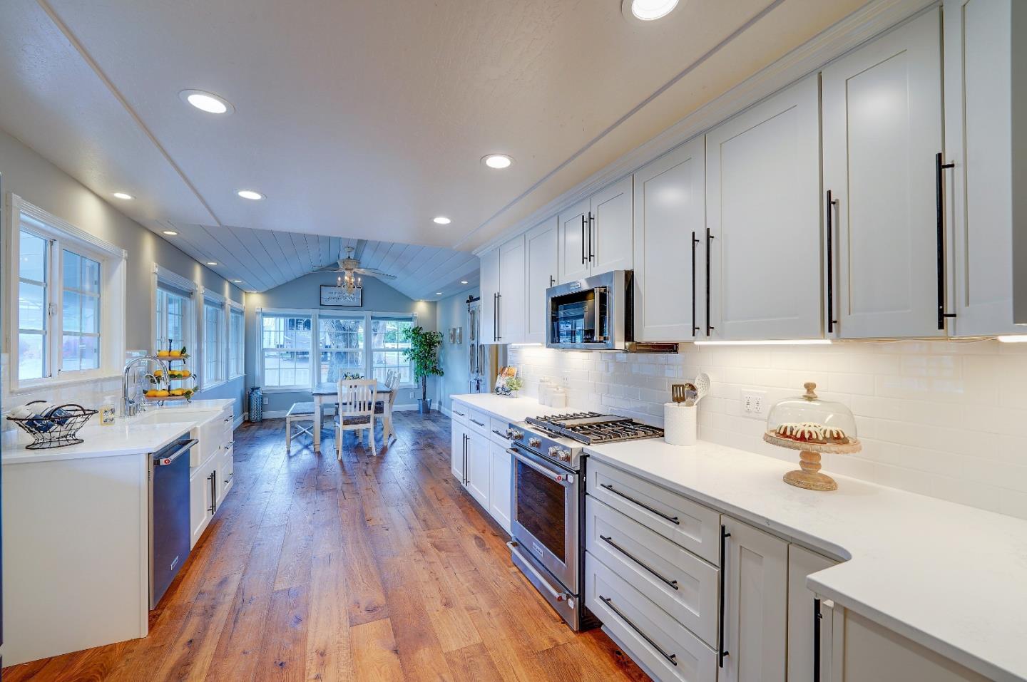 8495 Pharmer Road Gilroy, CA 95020 - Photo 12 of 70 a kitchen with stainless steel appliances granite countertop a lot of counter space and wooden floors