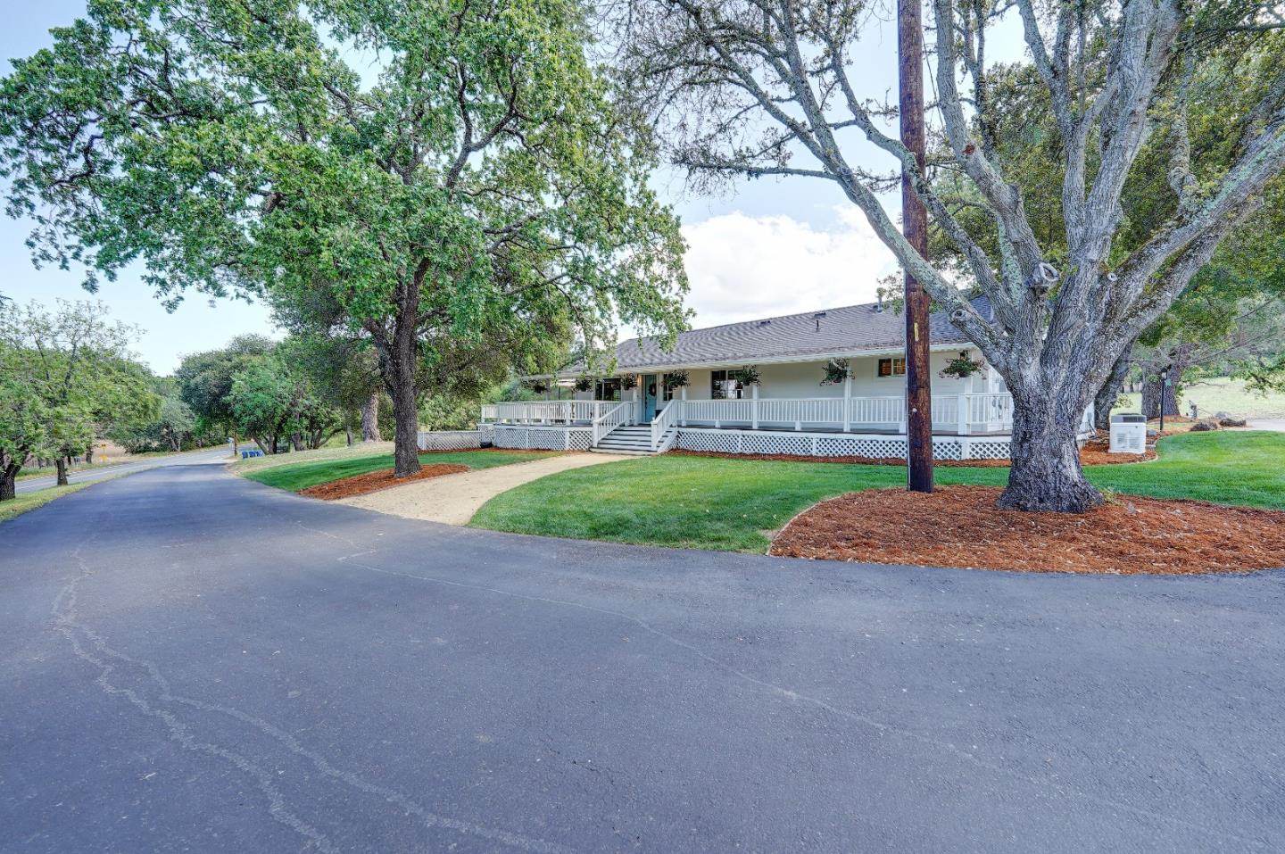 8495 Pharmer Road Gilroy, CA 95020 - Photo 4 of 70 a view of a house with a big yard and large tree