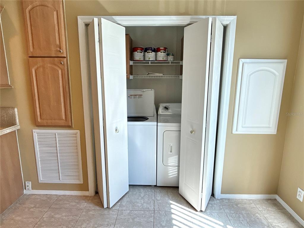 6817 Mt Pleasant Road Northeast, Unit 49 St. Petersburg, FL 33702 - Photo 12 of 30 a view of a hallway with wooden shelves