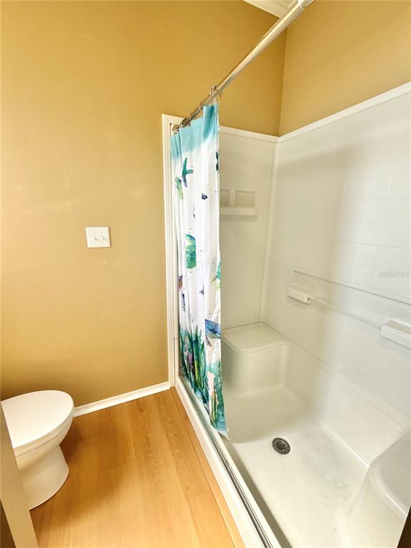 6817 Mt Pleasant Road Northeast, Unit 49 St. Petersburg, FL 33702 - Photo 21 of 30 a bathroom with a shower and a toilet