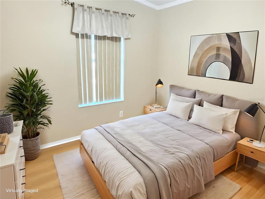 6817 Mt Pleasant Road Northeast, Unit 49 St. Petersburg, FL 33702 - Photo 23 of 30 a bedroom with a large bed and a potted plant