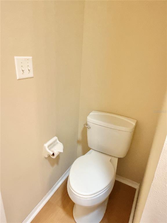 6817 Mt Pleasant Road Northeast, Unit 49 St. Petersburg, FL 33702 - Photo 26 of 30 a white toilet sitting next to a white wall