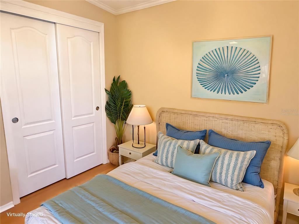 6817 Mt Pleasant Road Northeast, Unit 49 St. Petersburg, FL 33702 - Photo 27 of 30 a bedroom with a bed and a painting on the wall
