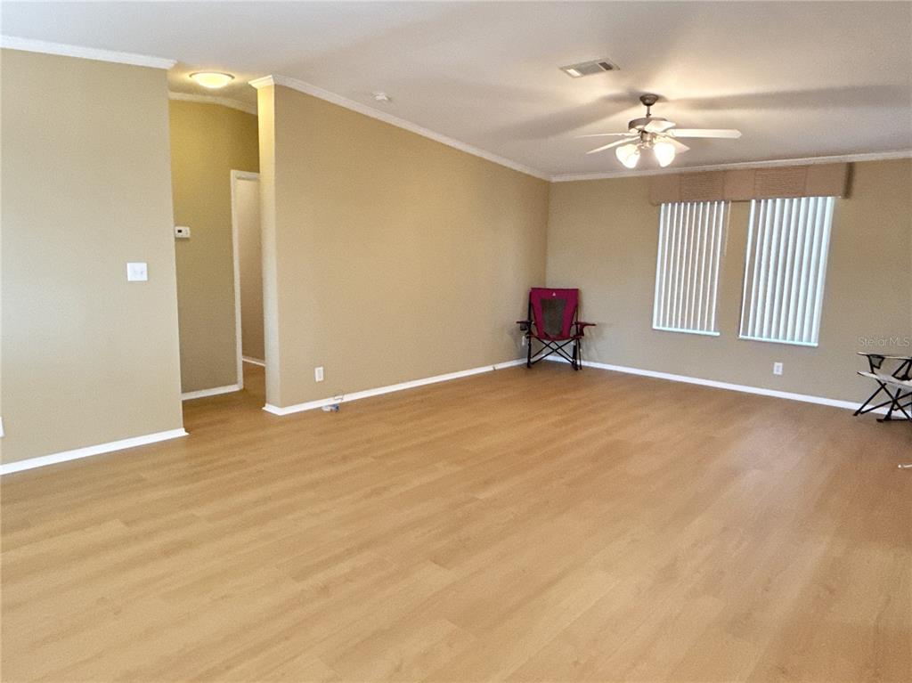 6817 Mt Pleasant Road Northeast, Unit 49 St. Petersburg, FL 33702 - Photo 4 of 30 a view of an empty room with a chandelier fan