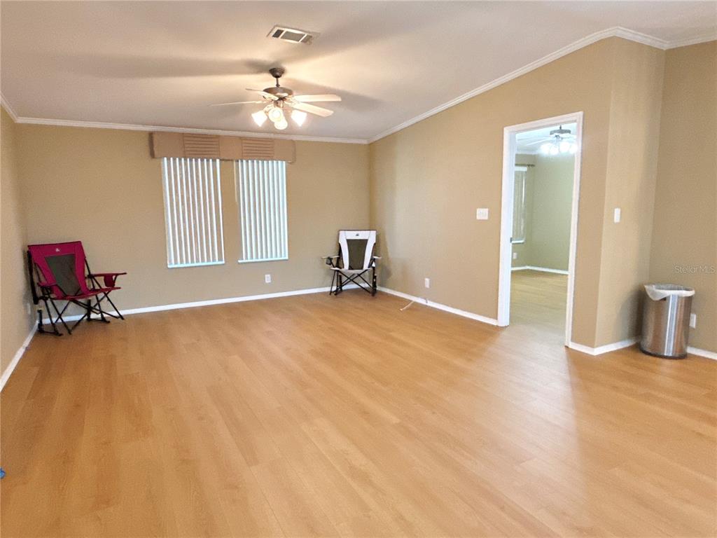 6817 Mt Pleasant Road Northeast, Unit 49 St. Petersburg, FL 33702 - Photo 5 of 30 an empty room with windows and ceiling fan