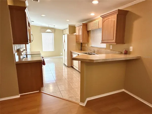 a kitchen with stainless steel appliances granite countertop a sink a stove and a refrigerator