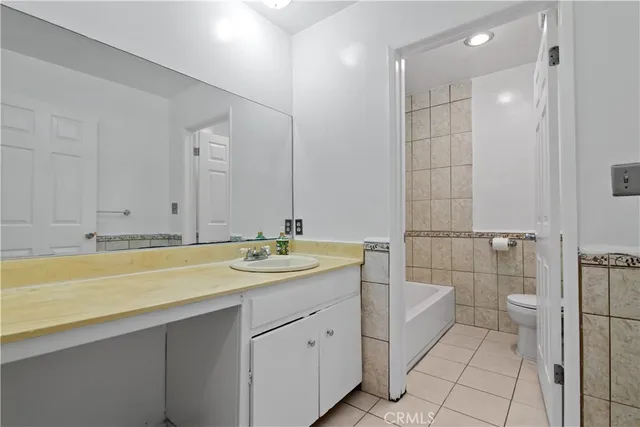 a bathroom with a granite countertop sink mirror and vanity