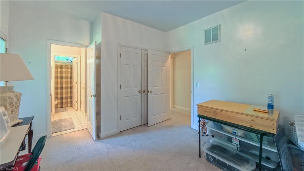 910 Whitney Court High Point, NC 27265 - Photo 18 of 24 Third bedroom is currently used as a craft room and has direct access to the covered porch.