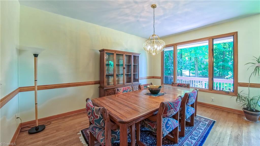 910 Whitney Court High Point, NC 27265 - Photo 5 of 24 The dining room will fit a large table and takes full advantage of the beautiful back yard as well.