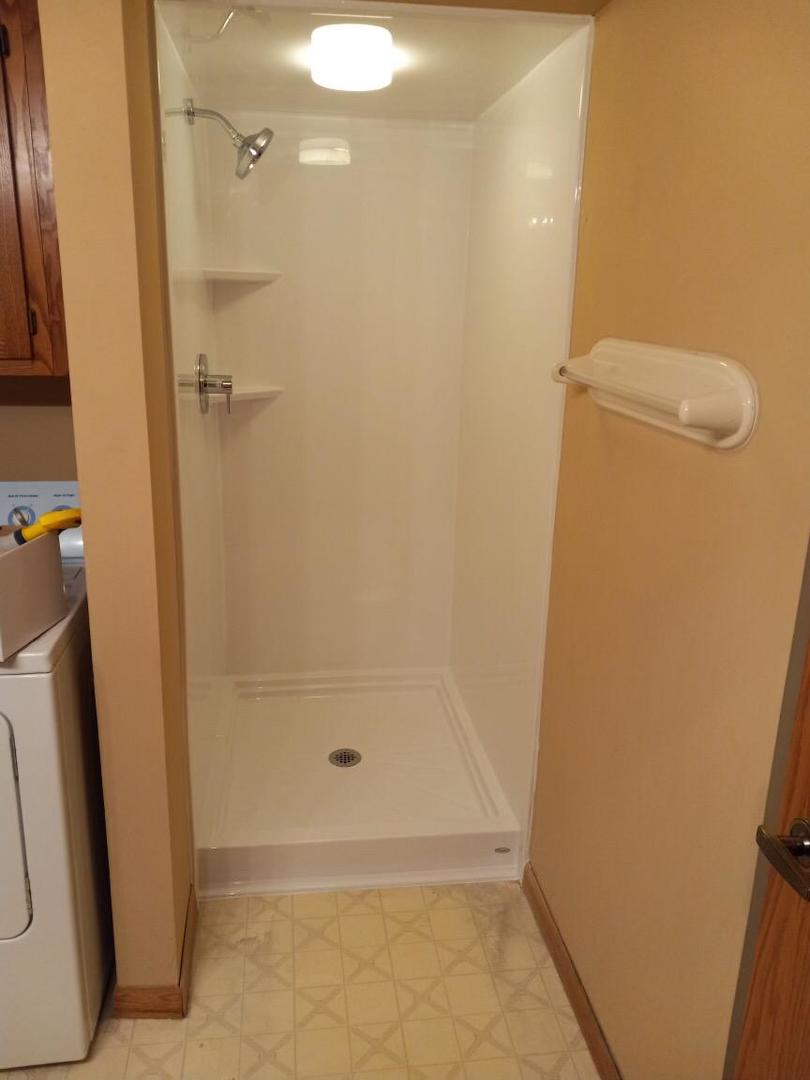 937 East Division Street, Unit 2D Lockport, IL 60441 - Photo 16 of 18 a bathroom with a granite countertop shower and a sink