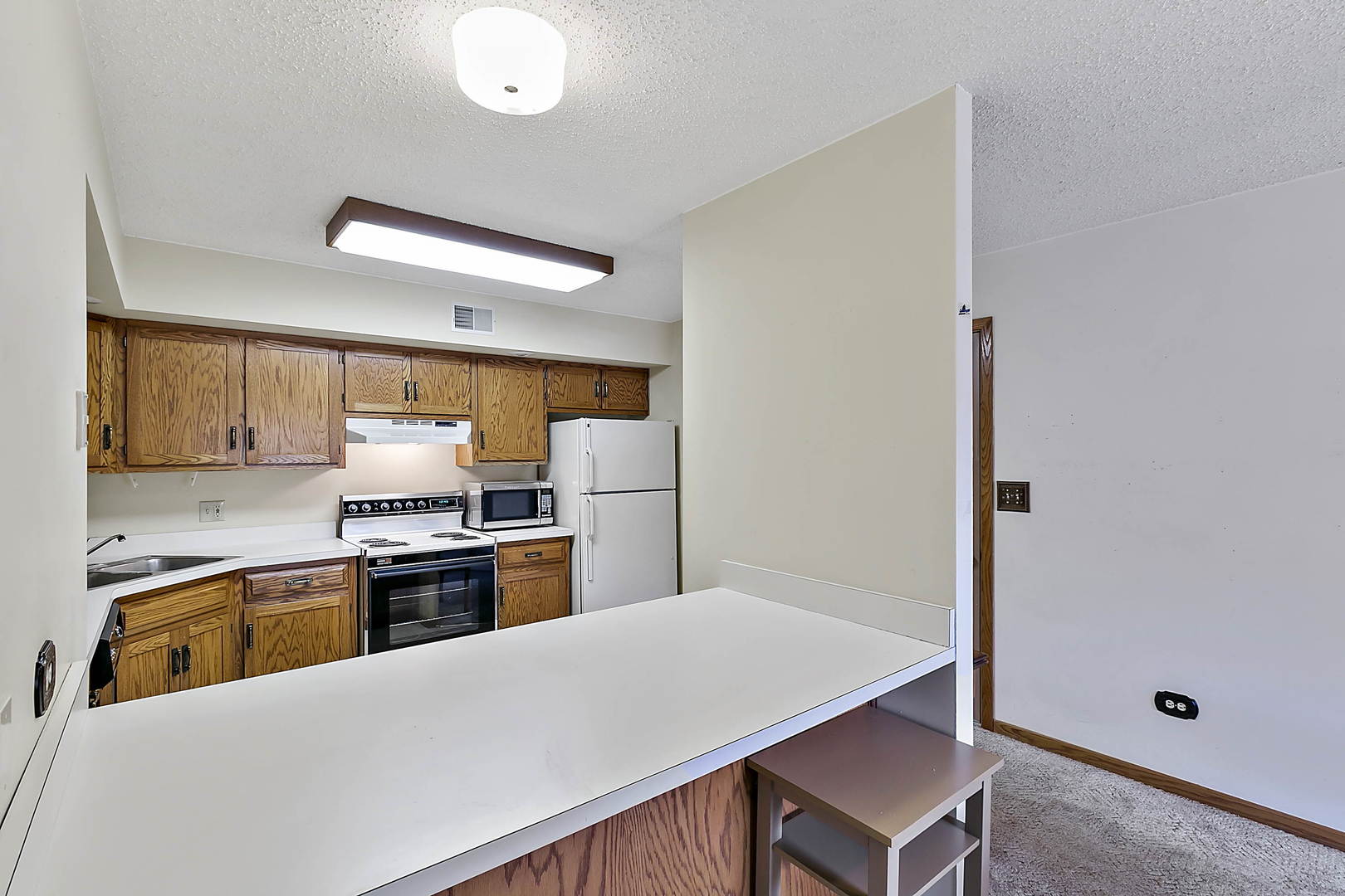 937 East Division Street, Unit 2D Lockport, IL 60441 - Photo 6 of 18 a kitchen with cabinets and wooden floor