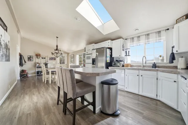 a kitchen with lots of wooden furniture appliances and cabinets