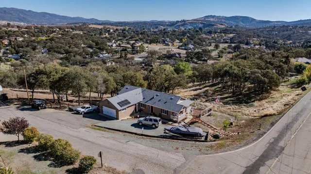 an aerial view of a house with a yard