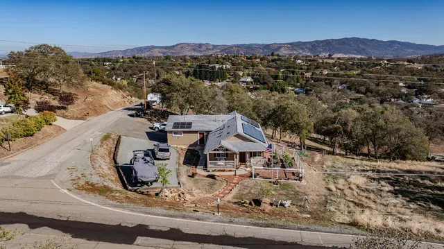 a view of a house with a mountain in the background