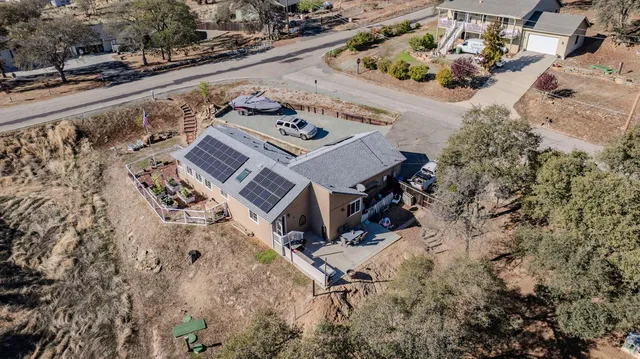 an aerial view of a house with a yard