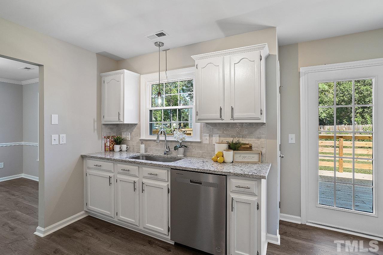 3537 Limber Lane Raleigh, NC 27616 - Photo 8 of 30 a kitchen with a white cabinets and window