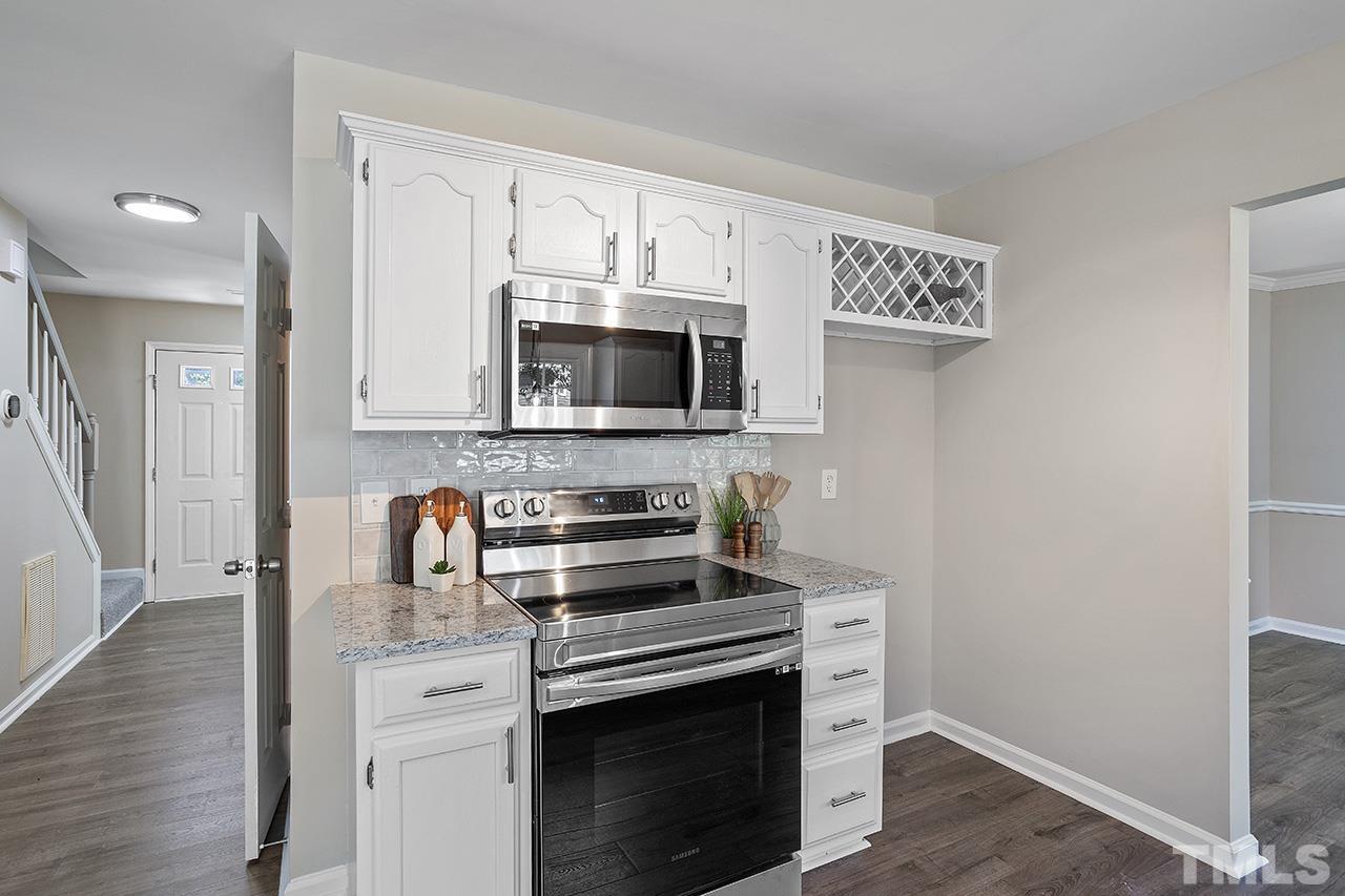 3537 Limber Lane Raleigh, NC 27616 - Photo 9 of 30 a kitchen with stainless steel appliances a stove microwave and sink