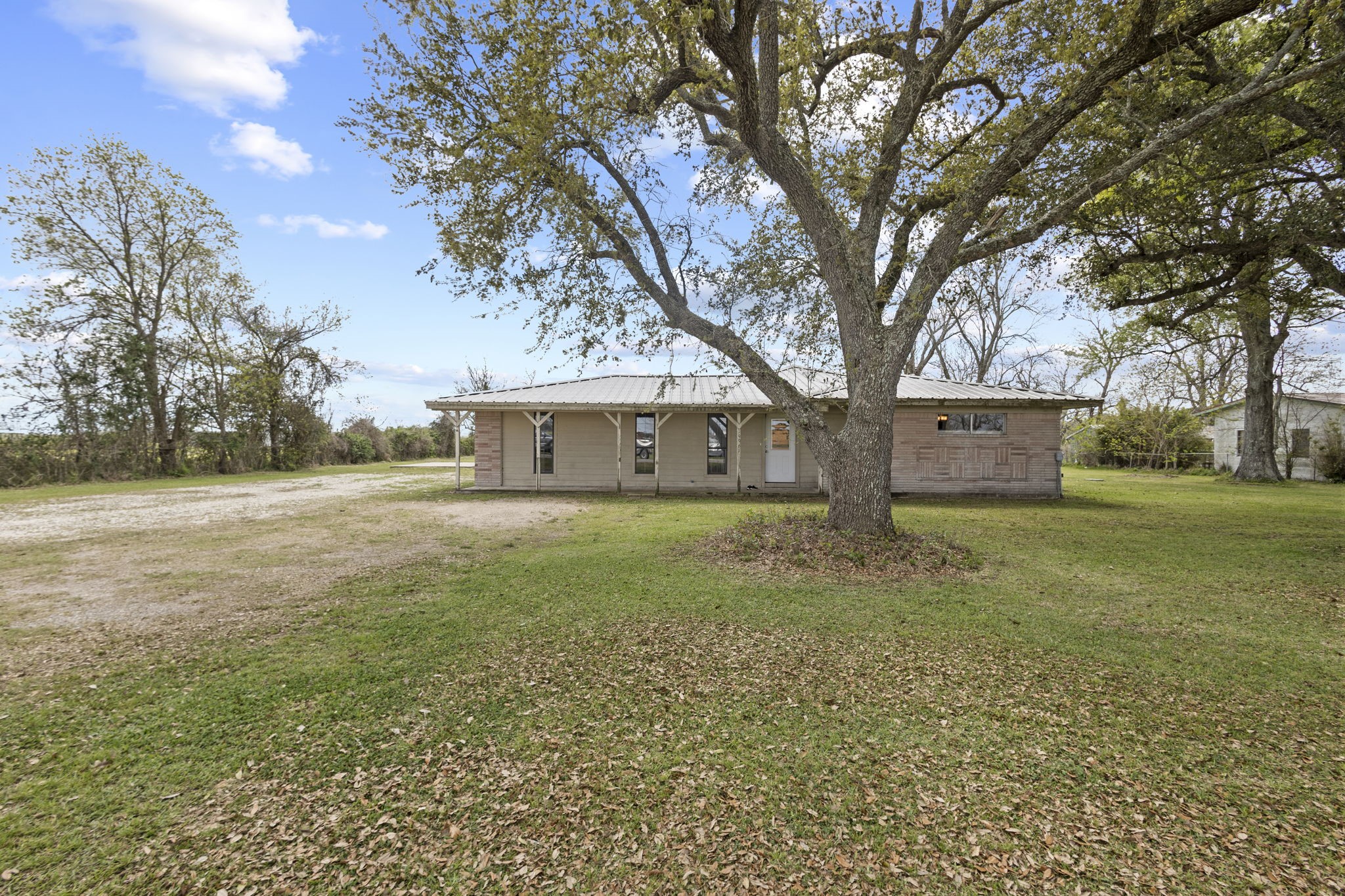 19961 Englin Road Winnie, TX 77665 - Photo 2 of 26 a front view of house with yard and green space