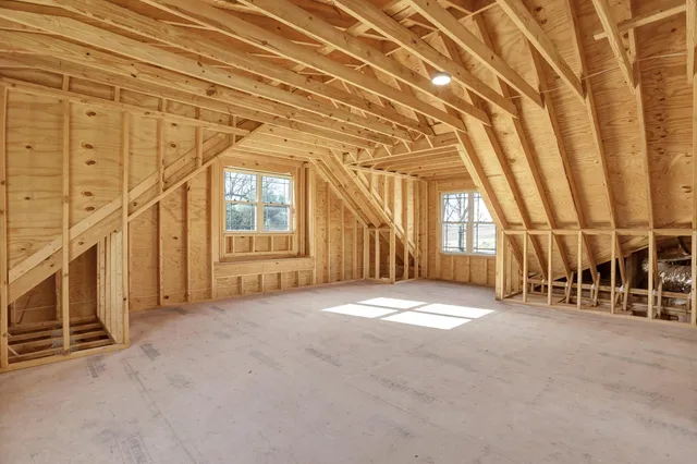 a view of an empty room with windows