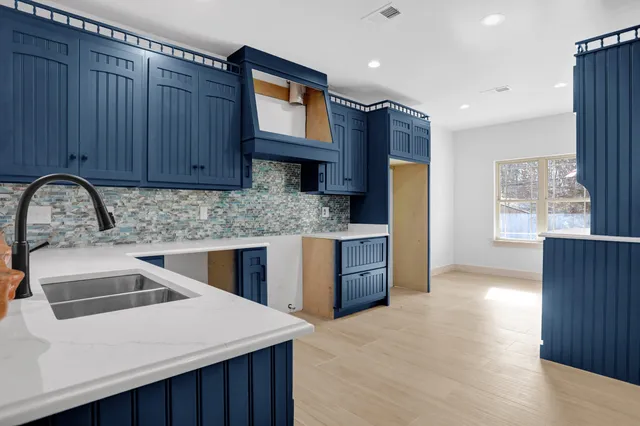 a kitchen that has a sink and a stove in it