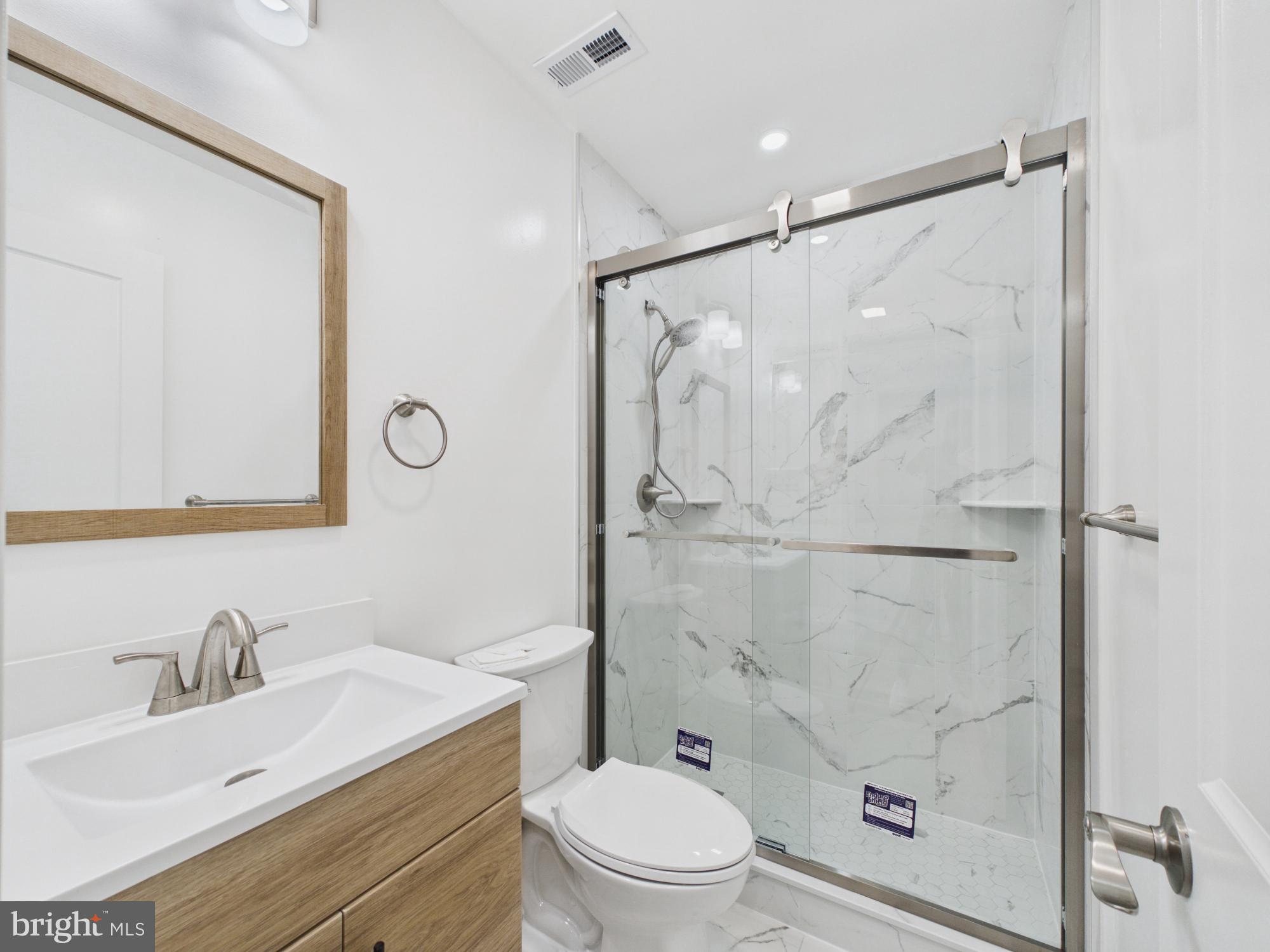 3629 Warren Street Philadelphia, PA 19104 - Photo 13 of 17 a bathroom with a sink toilet vanity and shower
