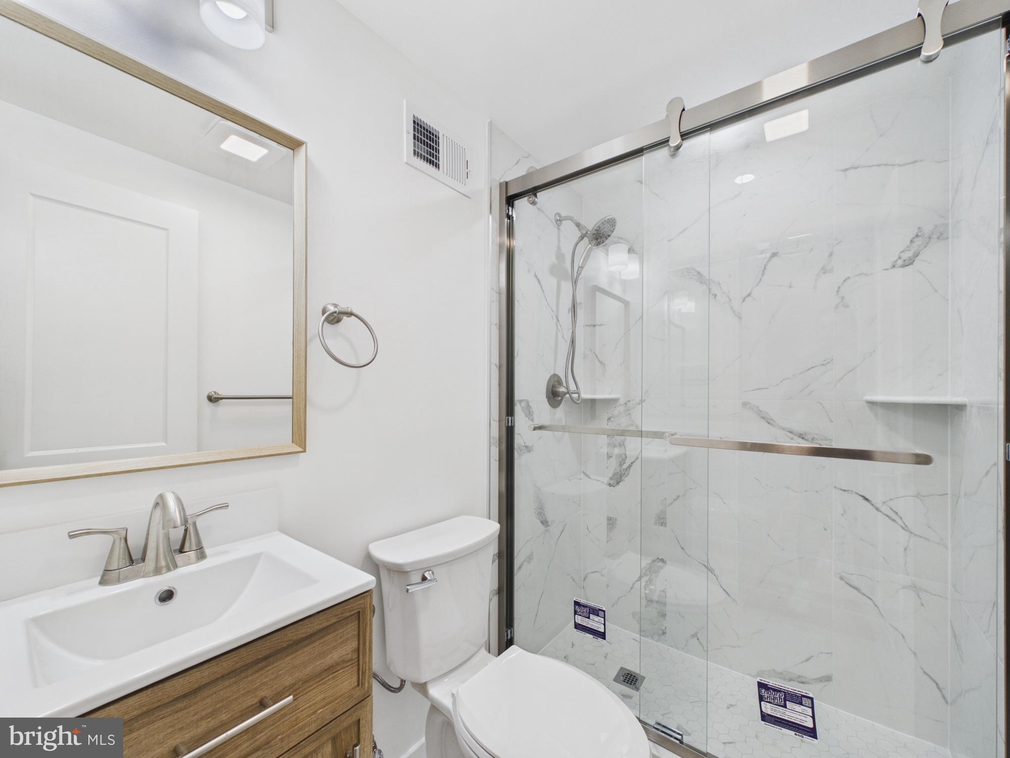 3629 Warren Street Philadelphia, PA 19104 - Photo 15 of 17 a bathroom with a sink toilet and shower