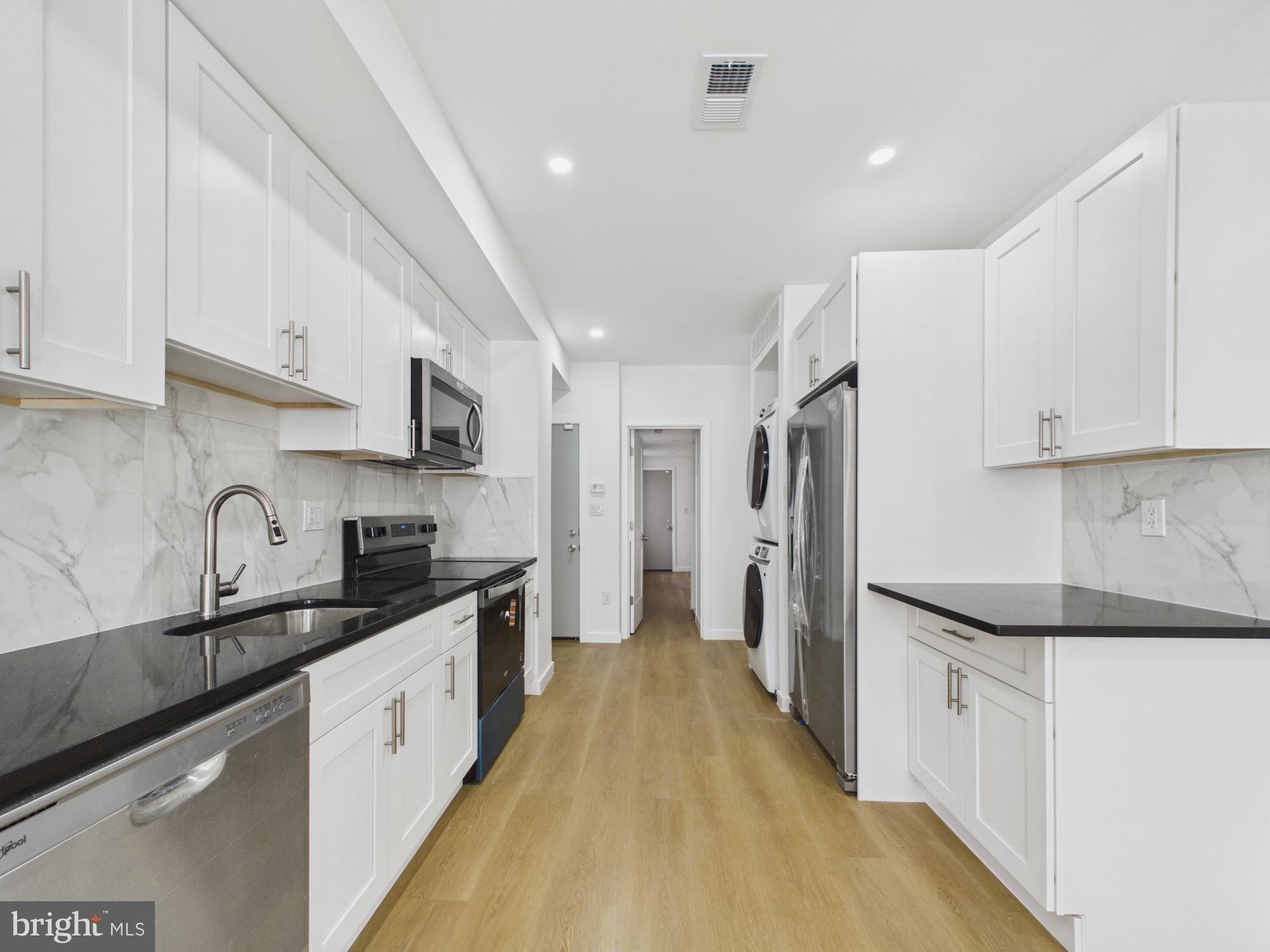 3629 Warren Street Philadelphia, PA 19104 - Photo 2 of 17 a kitchen with stainless steel appliances a sink stove refrigerator and cabinets