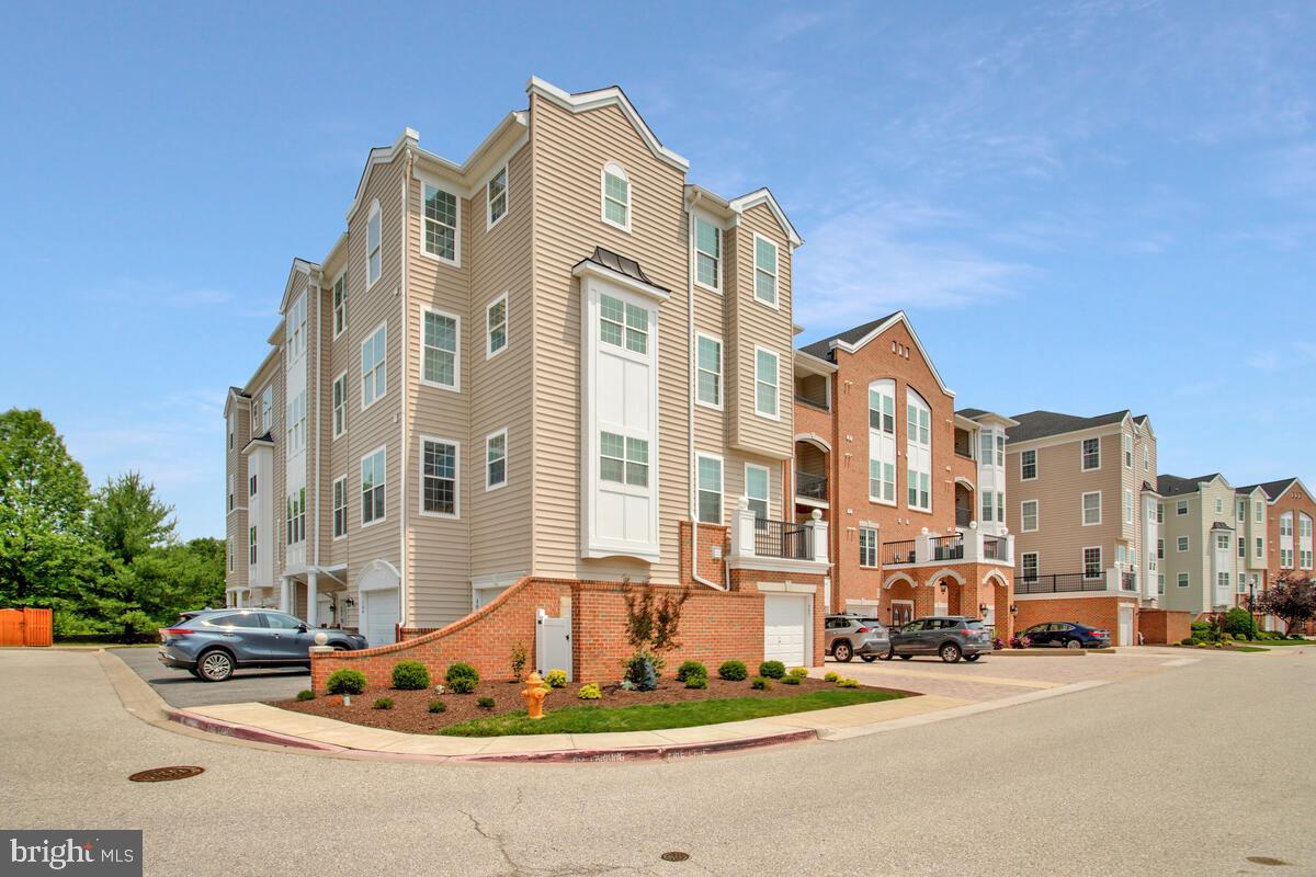 7305 Maplecrest Road, Unit 206 Elkridge, MD 21075 - Photo 1 of 62 a front view of a building with lot of cars and trees