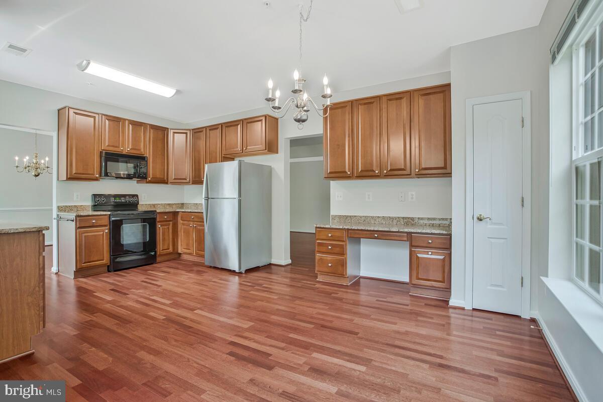 7305 Maplecrest Road, Unit 206 Elkridge, MD 21075 - Photo 15 of 62 a kitchen with stainless steel appliances granite countertop a refrigerator microwave and sink