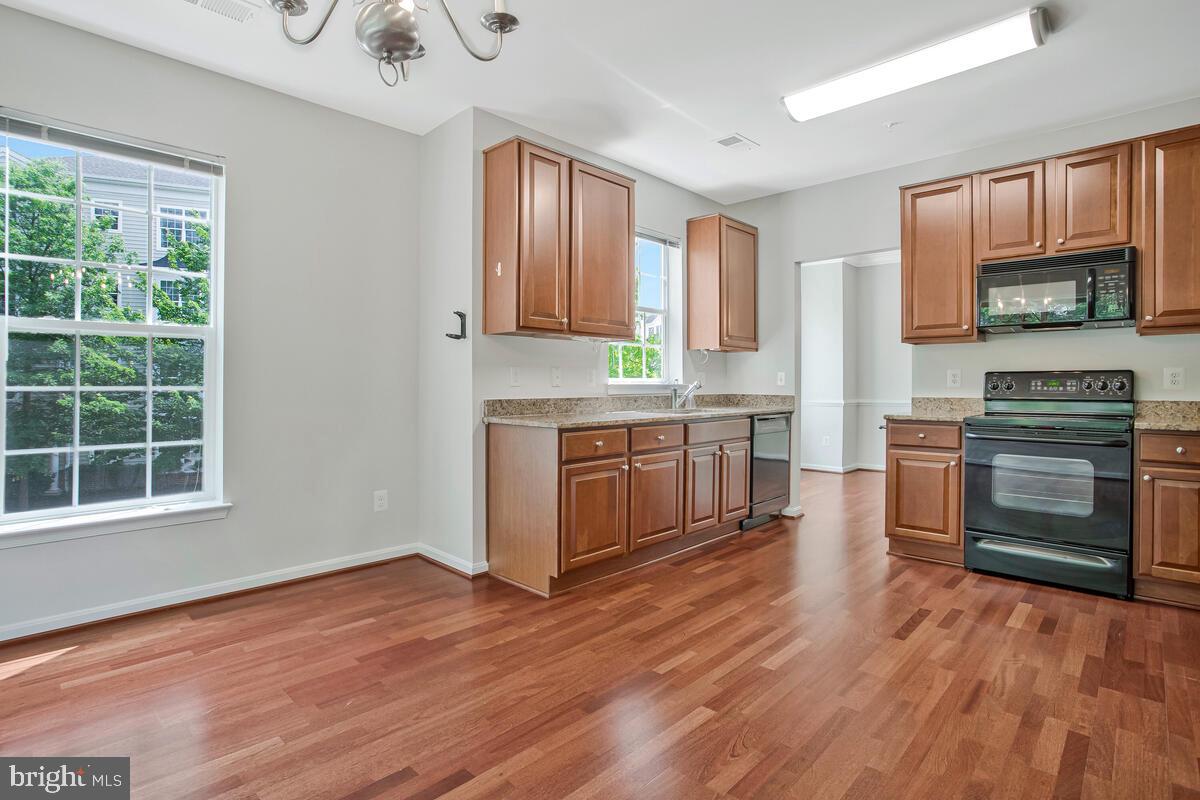 7305 Maplecrest Road, Unit 206 Elkridge, MD 21075 - Photo 16 of 62 a kitchen with a stove a sink and a microwave