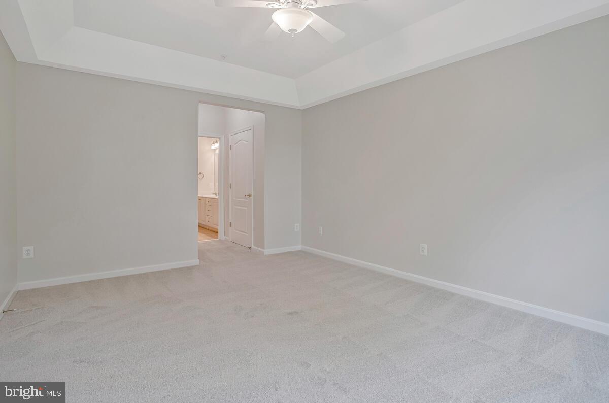 7305 Maplecrest Road, Unit 206 Elkridge, MD 21075 - Photo 23 of 62 an empty room with a ceiling fan and a window