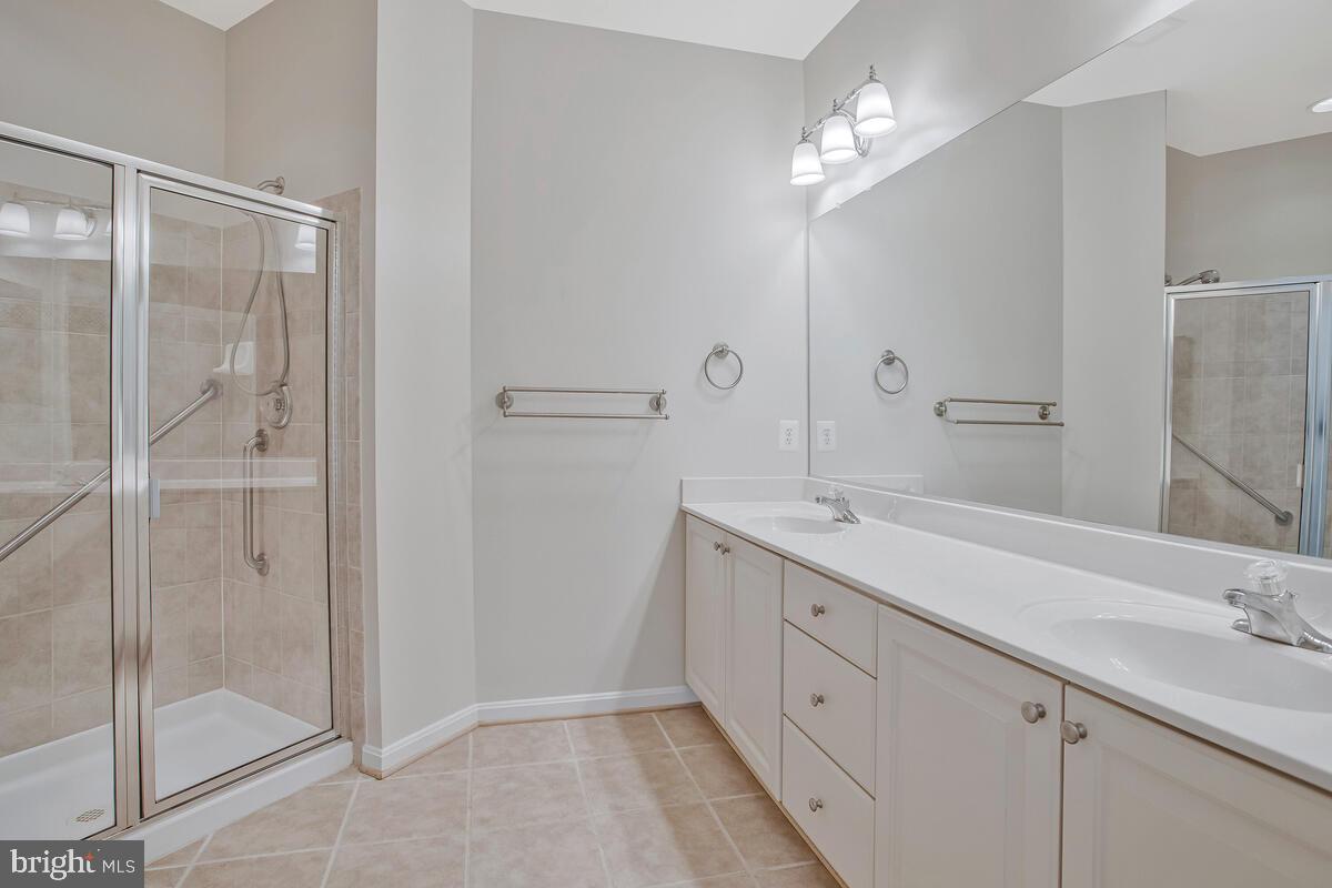 7305 Maplecrest Road, Unit 206 Elkridge, MD 21075 - Photo 25 of 62 a spacious bathroom with a double vanity sink and a mirror