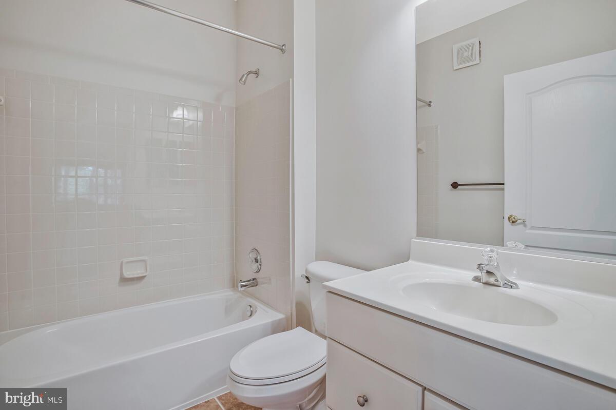 7305 Maplecrest Road, Unit 206 Elkridge, MD 21075 - Photo 28 of 62 a bathroom with a granite countertop sink toilet and shower