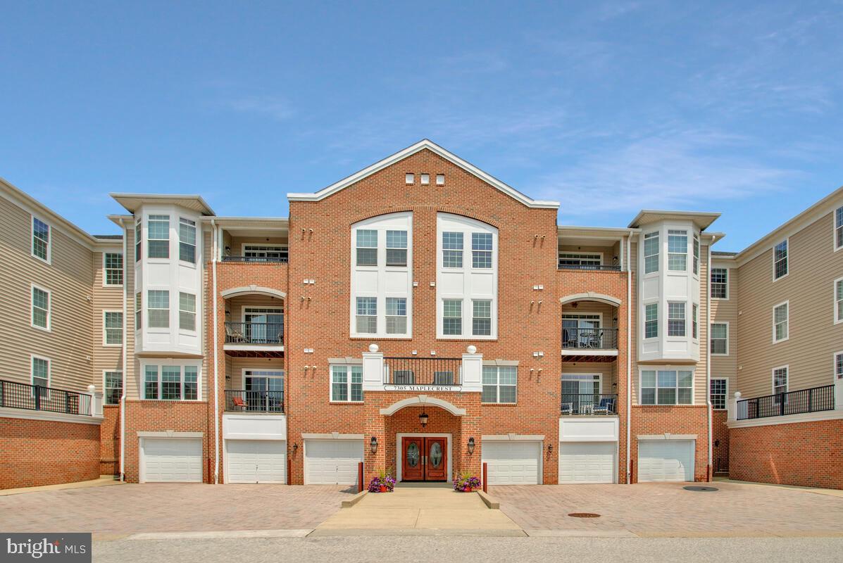 7305 Maplecrest Road, Unit 206 Elkridge, MD 21075 - Photo 3 of 62 a front view of a residential apartment building with a yard