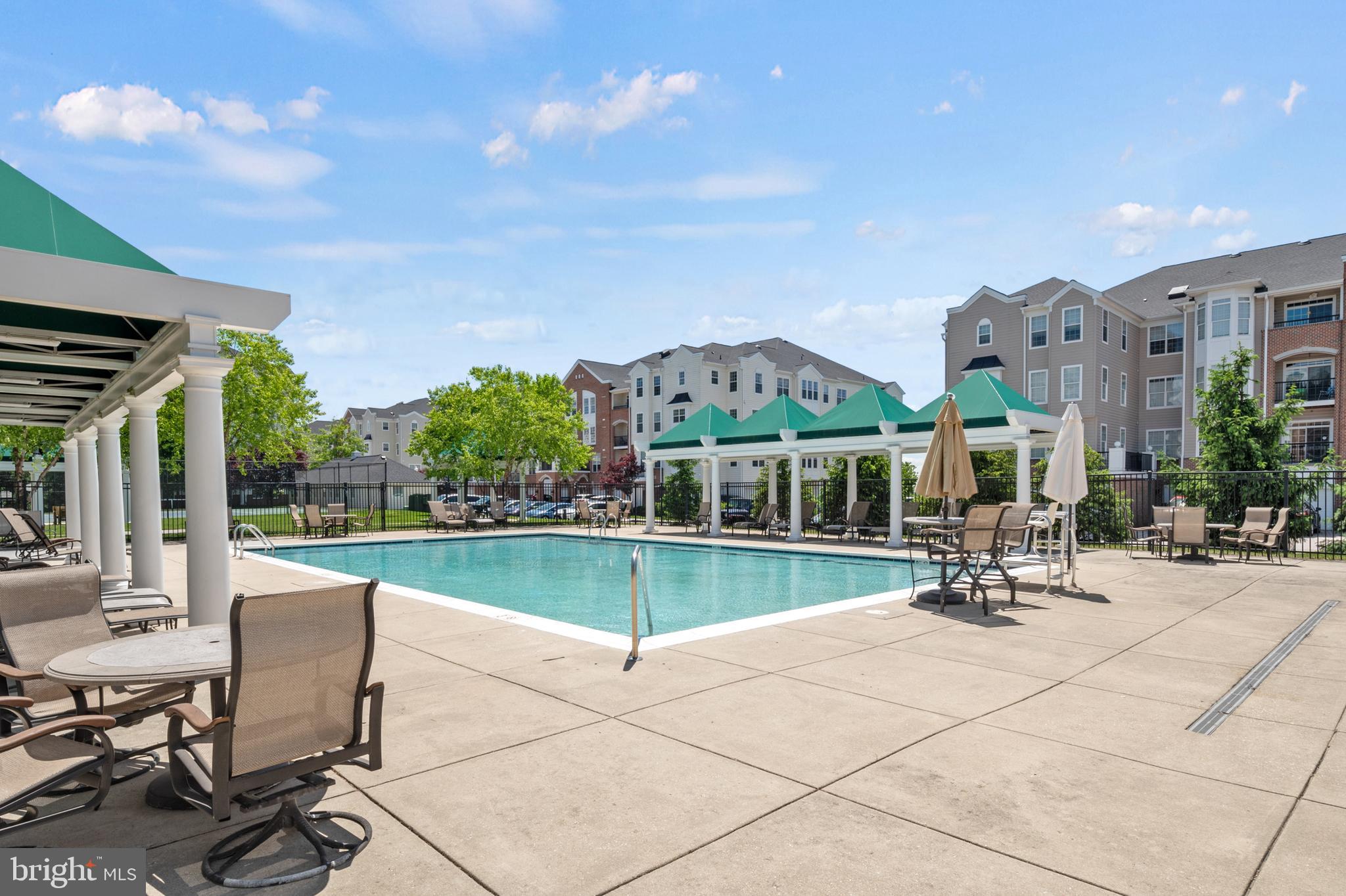 7305 Maplecrest Road, Unit 206 Elkridge, MD 21075 - Photo 55 of 62 a view of a patio with a table and chairs