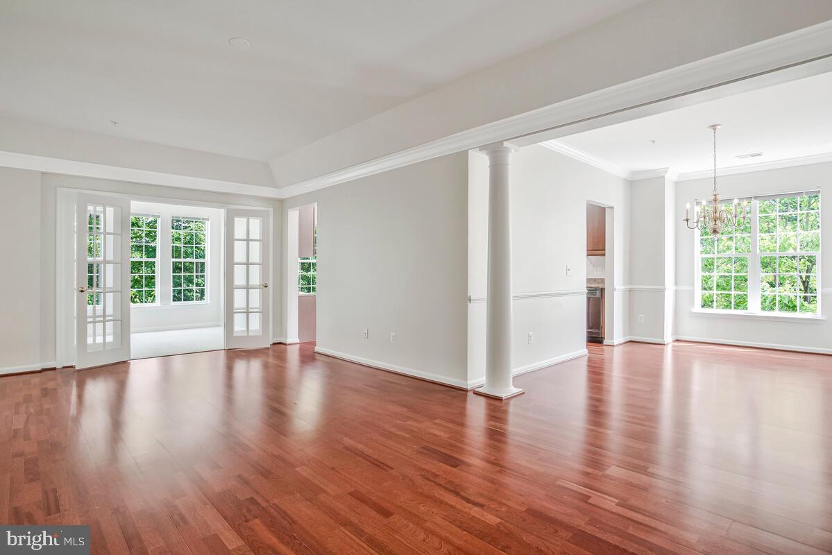 7305 Maplecrest Road, Unit 206 Elkridge, MD 21075 - Photo 7 of 62 a view of an empty room with wooden floor and a window