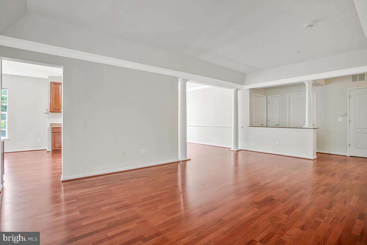 7305 Maplecrest Road, Unit 206 Elkridge, MD 21075 - Photo 9 of 62 a view of an empty room with wooden floor and a window