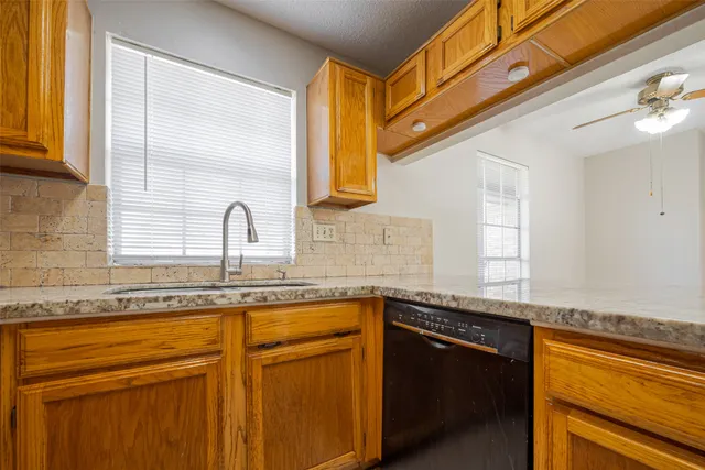 a kitchen with stainless steel appliances granite countertop a sink and a cabinets