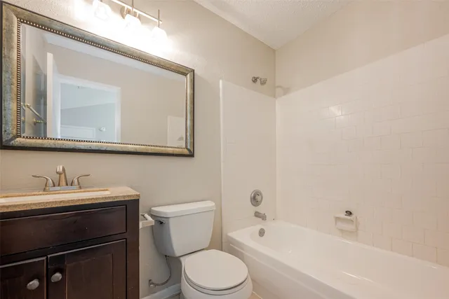 a bathroom with a sink a toilet and a bathtub