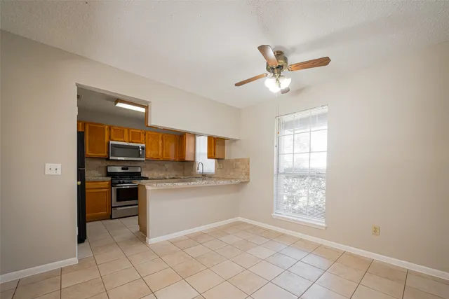 a kitchen with cabinets and window