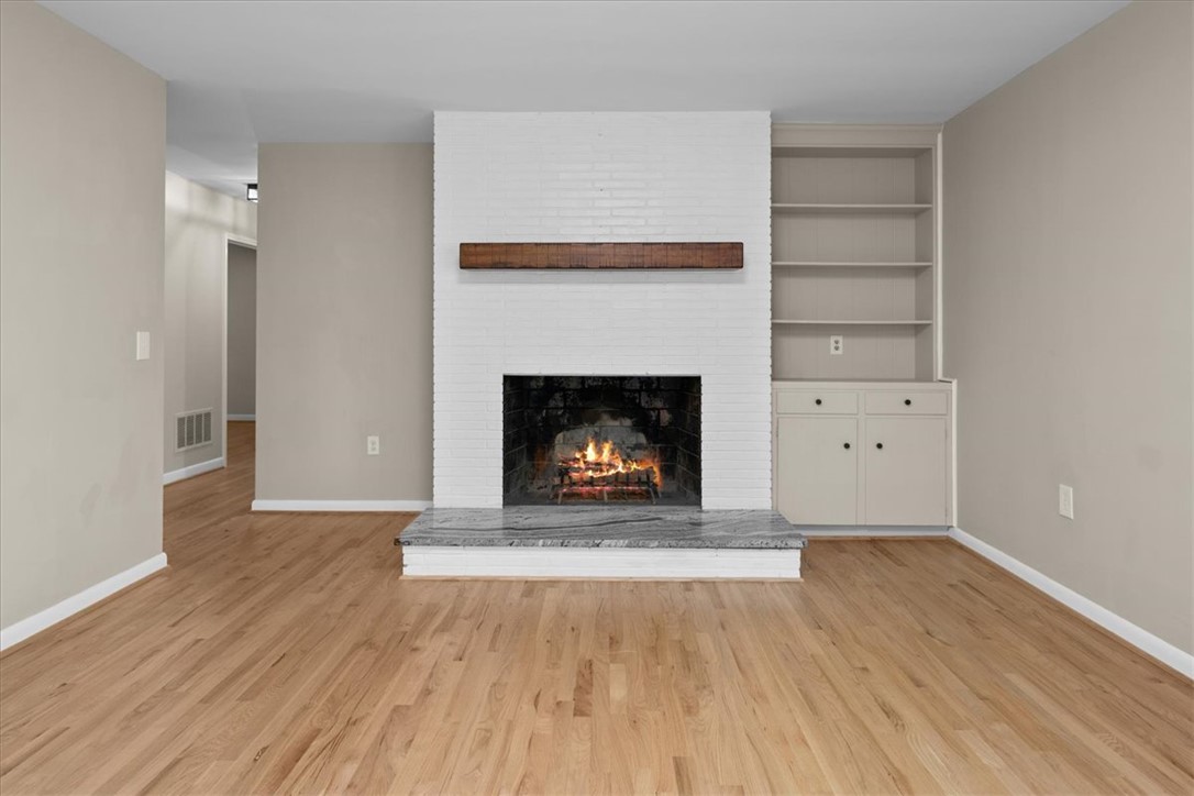103 Satula Lane Clemson, SC 29631 - Photo 11 of 50 Warm and inviting living space with a crackling fireplace and beautiful hardwood floors.