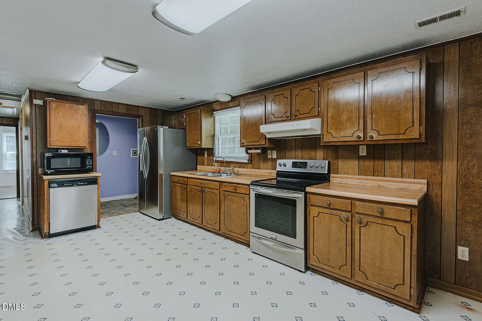 1302 Blacksmith Road Efland, NC 27243 - Photo 5 of 46 a kitchen with granite countertop stainless steel appliances and wooden cabinets