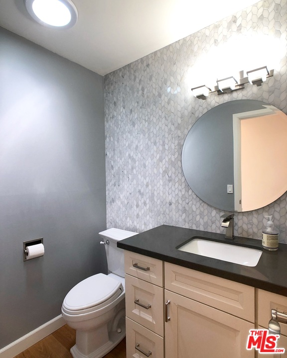 18325 Coastline Drive Malibu, CA 90265 - Photo 16 of 20 a bathroom with a granite countertop sink and a mirror