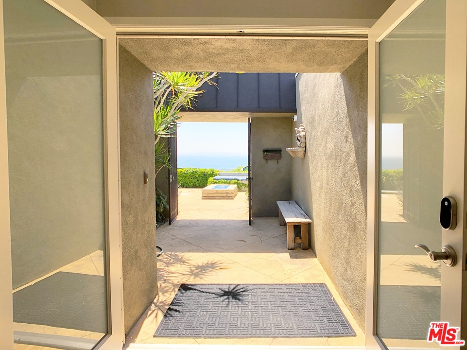 18325 Coastline Drive Malibu, CA 90265 - Photo 3 of 20 a bathroom with a shower and a toilet