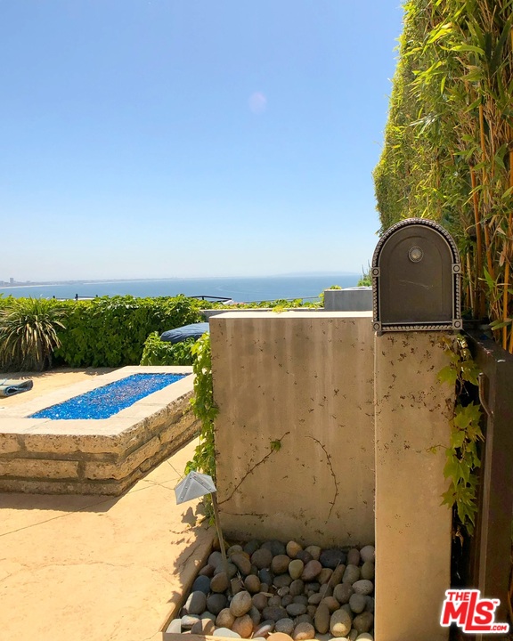 18325 Coastline Drive Malibu, CA 90265 - Photo 7 of 20 a view of a swimming pool with an outdoor space and seating area
