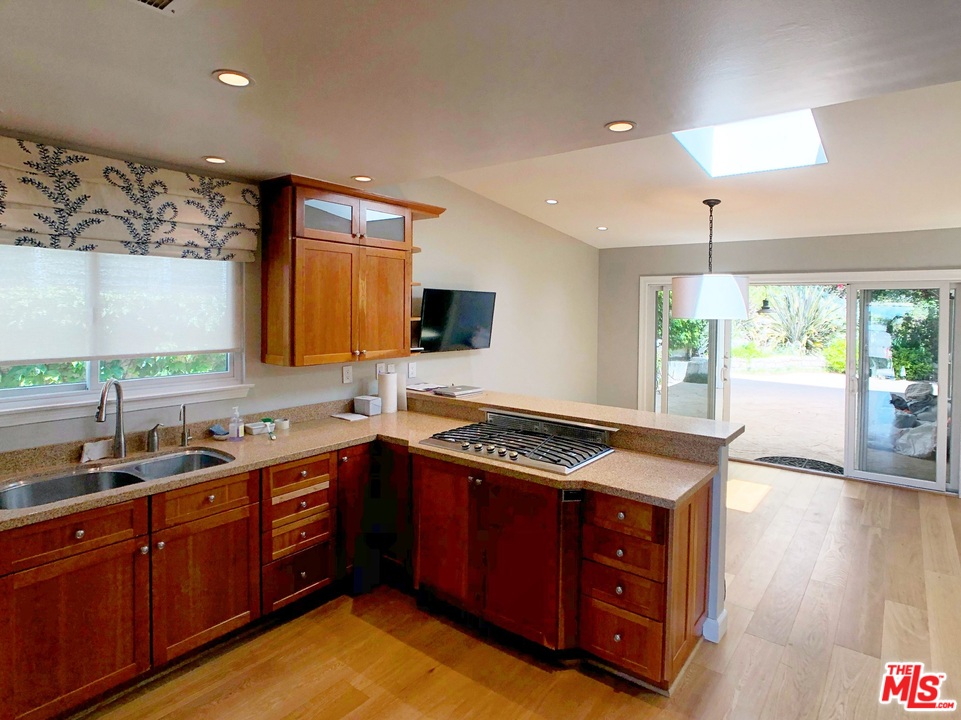 18325 Coastline Drive Malibu, CA 90265 - Photo 9 of 20 a kitchen with a stove a sink and a window