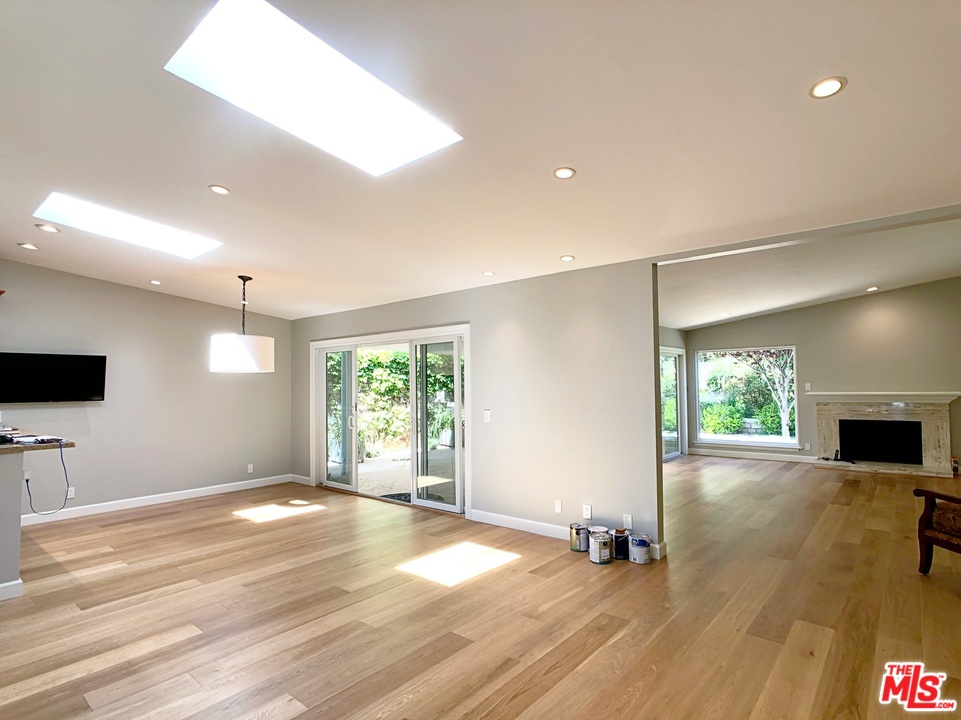 18325 Coastline Drive Malibu, CA 90265 - Photo 10 of 20 an empty room with wooden floor and windows