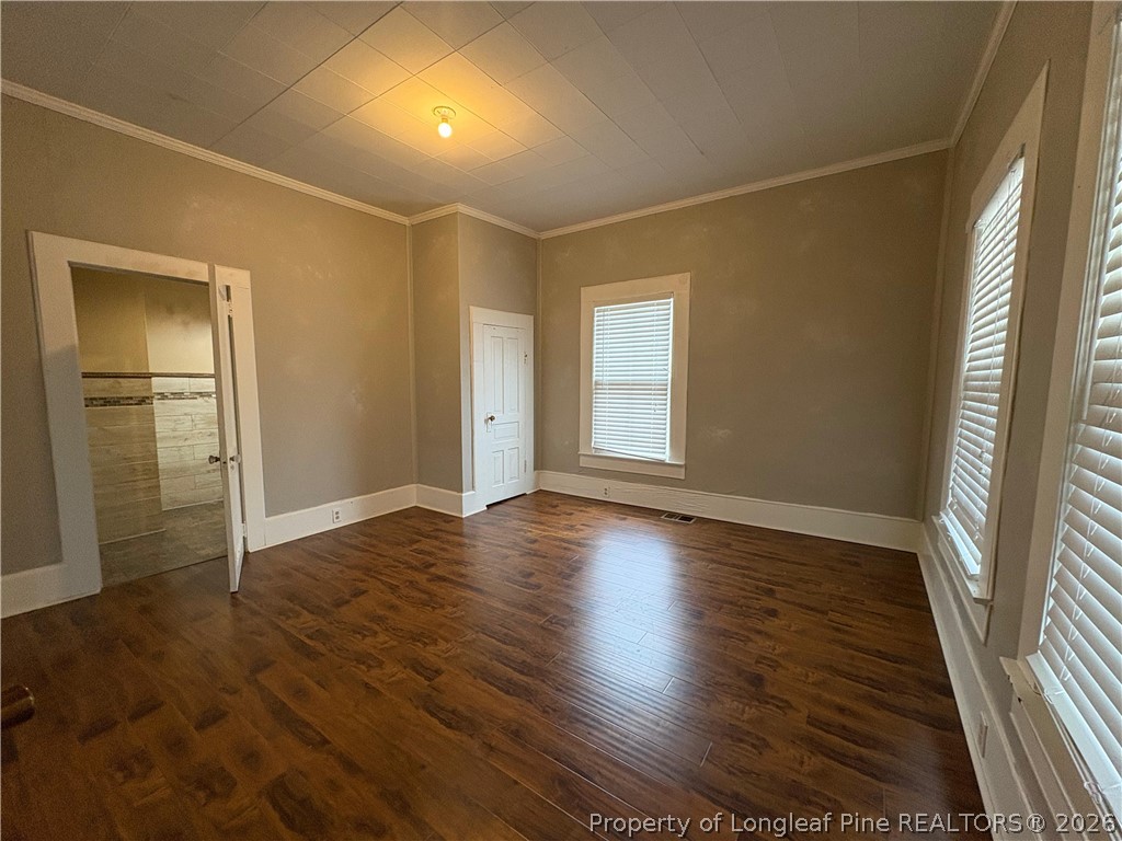 3174 Lindsay Road Raeford, NC 28376 - Photo 9 of 28 an empty room with wooden floor and windows